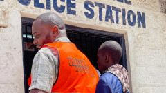 NTSA official and a matatu tout at a police station. PHOTO/COURTESY