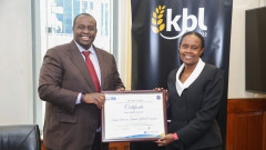 Energy and Petroleum Regulatory Authority (EPRA) Director General Mr. Daniel Kiptoo Bargoria presenting Kenya Breweries Limited Operations Director, Rosemary Mwaniki with the Certificate of Compliance. PHOTO/COURTESY