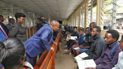 Kithure Kindiki speaking to passport applicants at Nyayo House. PHOTO/COURTESY