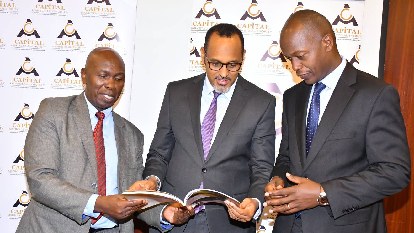 CEO FCPA Wyckliffe Shamiah, CMA Chairman Ugas Mohamed and the Nairobi Security Exchang Ag. CEO David Wainaina unveil the new 2023-2028 CMA strategic Plan during the Capital Market Industry Leaders’ Forum. PHOTO/COURTESY