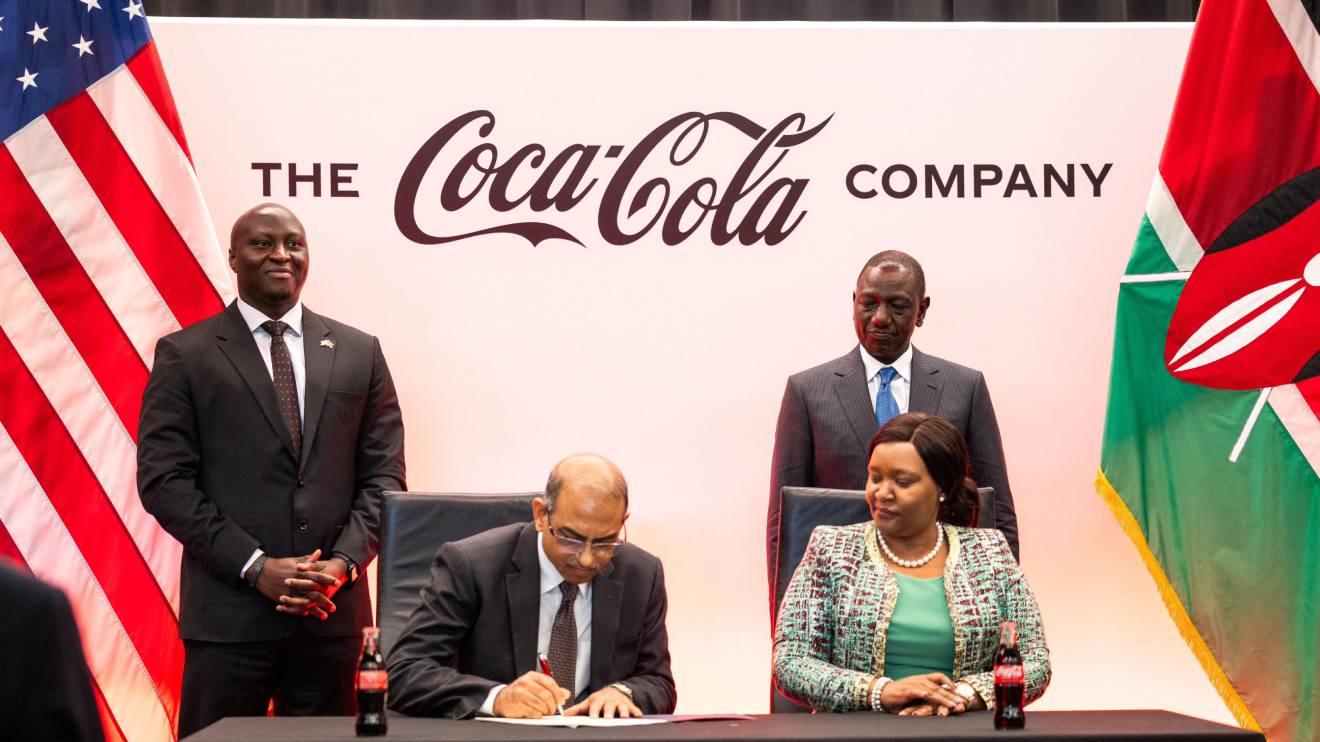 William Ruto (Standing Right) witnessing the signing of the Coca-cola deal. PHOTO/COURTESY