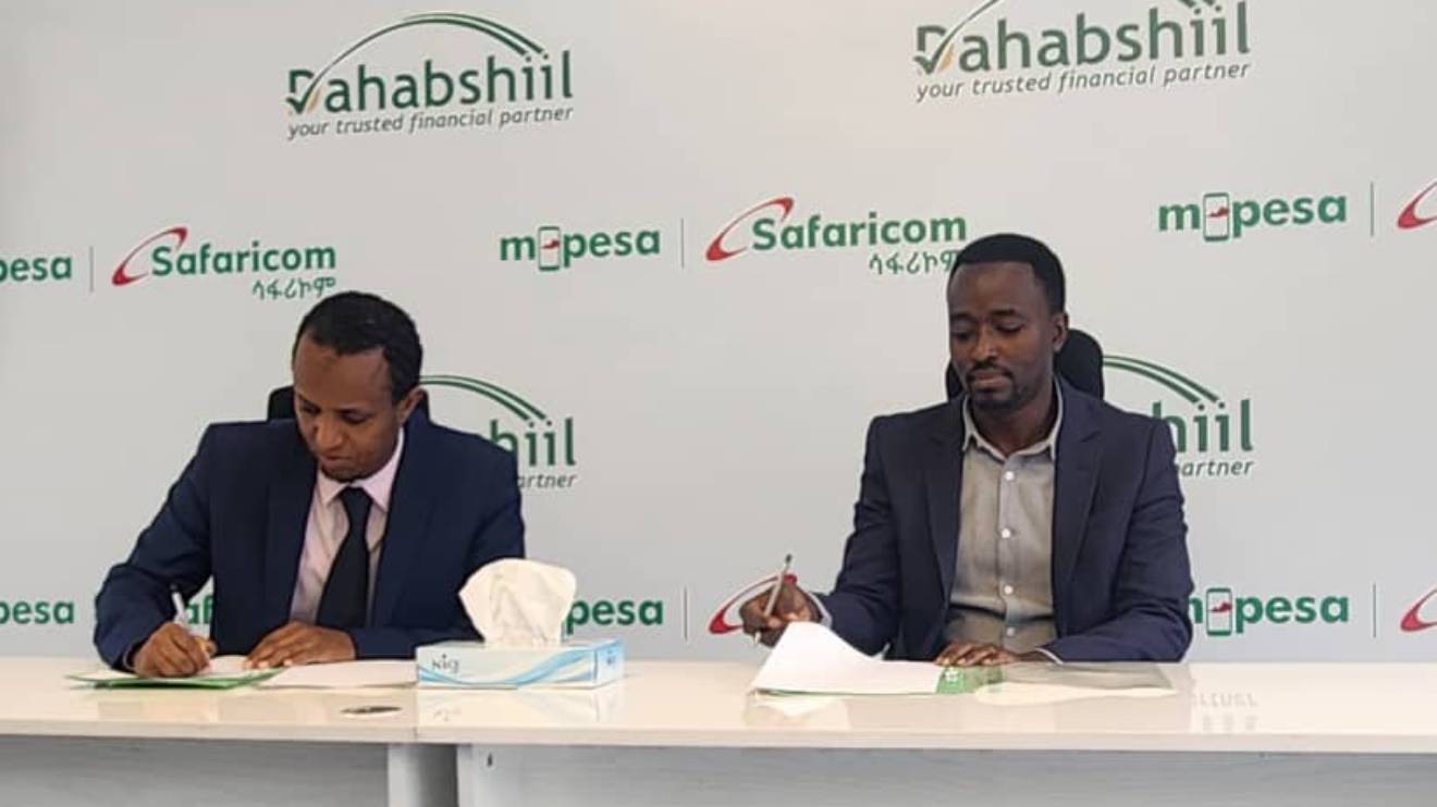Dahabshiil country representative in Ethiopia Musse Mohamed and M-Pesa Safaricom acting chief digital financial services officer Anthony Kangethe. PHOTO/COURTESY