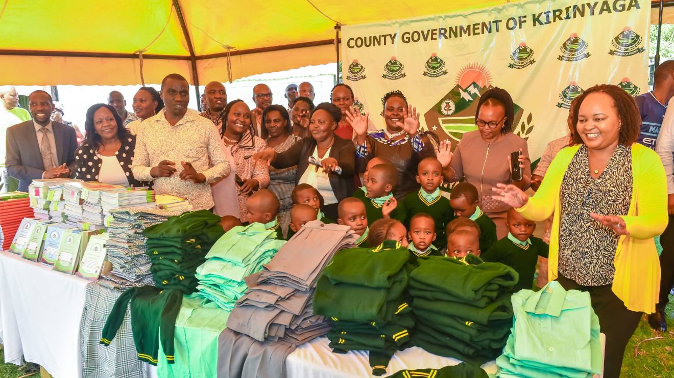 Anne Waiguru (extreme right) handing over the free uniforms to ECDE children. PHOTO/COURTESY