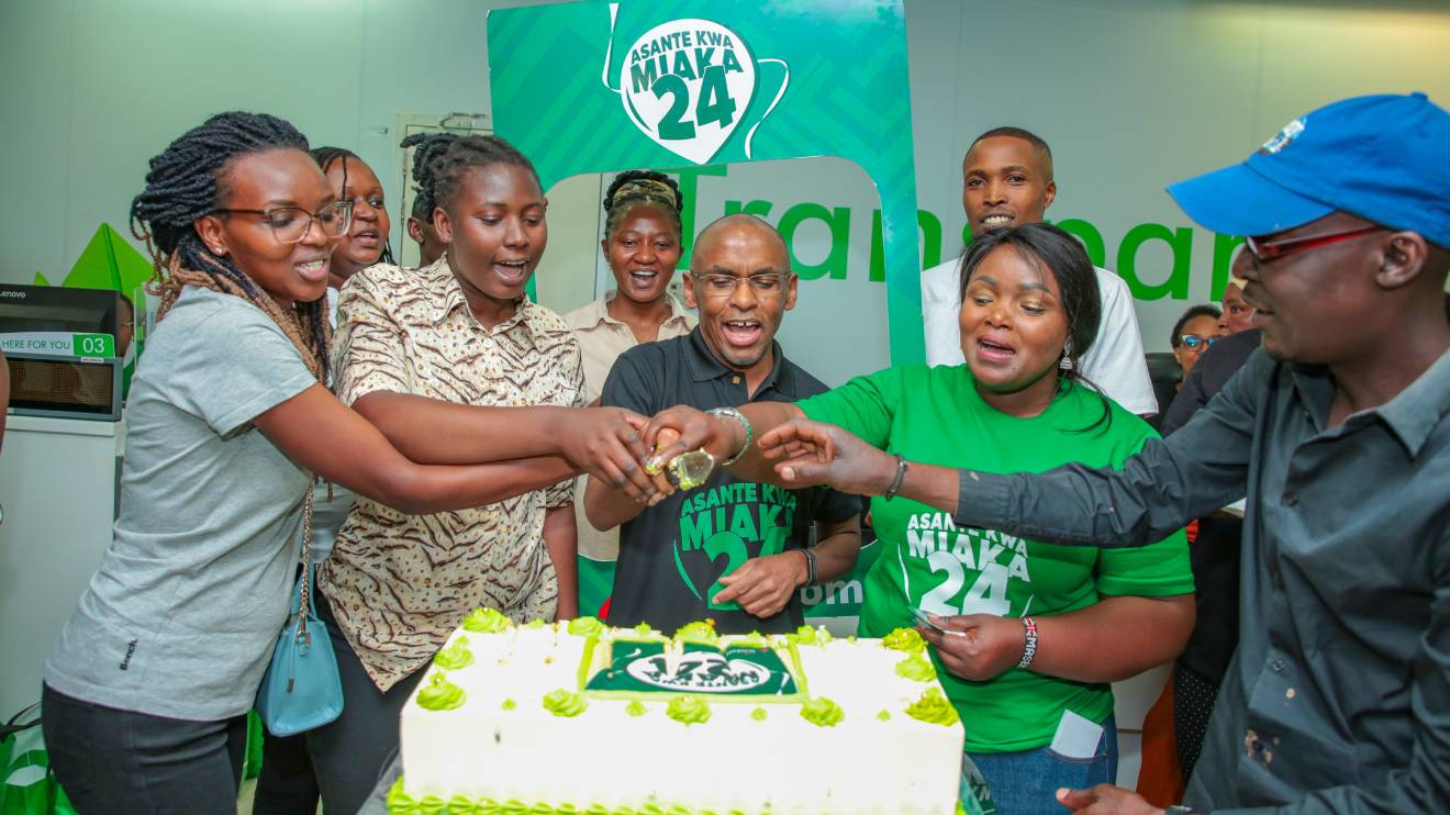 Ndegwa (centre) leads the team in cutting the cake as the company marks 24 years of transforming lives. PHOTO/COURTESY