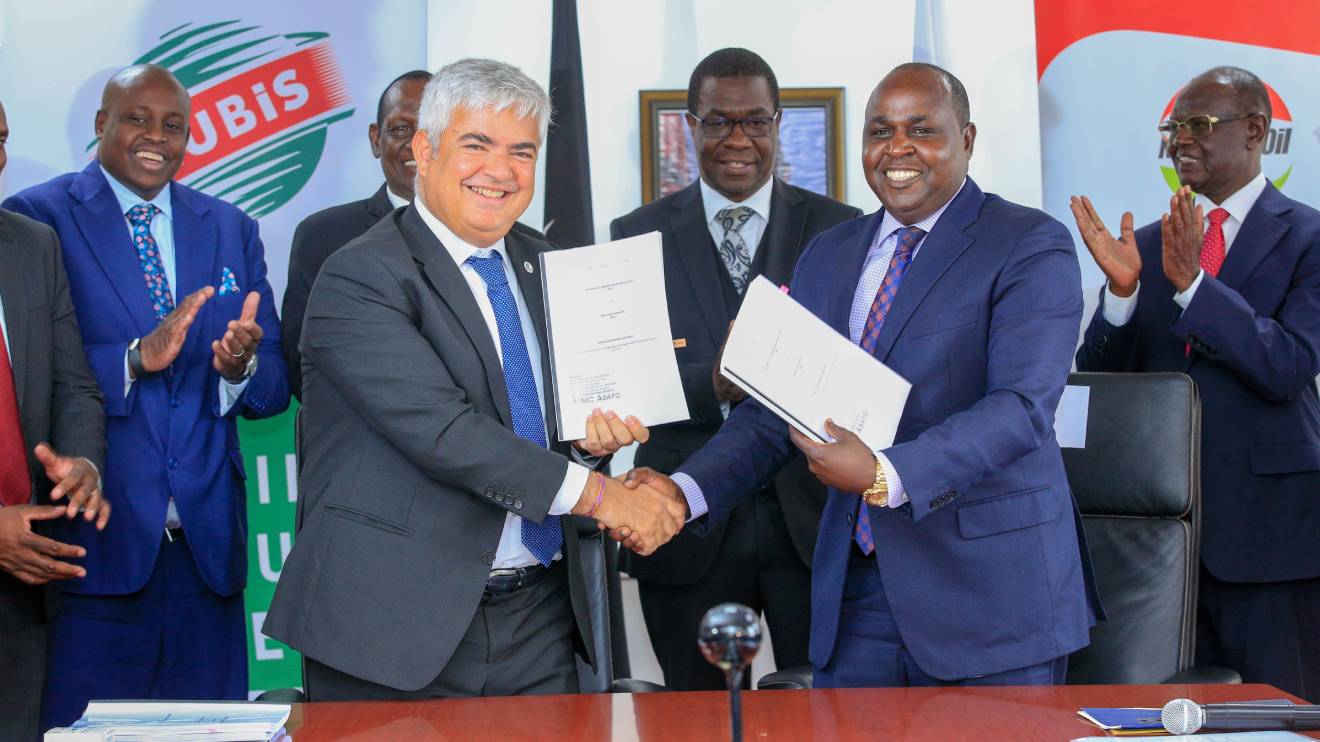 Left (in front): Olivier Sabrié and Leparan Ole Morintat shake hands after signing a non-equity strategic partnership agreement at Kawi. Looking on is (2nd row) Daniel Kiptoo Bargoria, Mohamed Liban, Opiyo Wandayi and Kiraitu Murungi. PHOTO/COURTESY