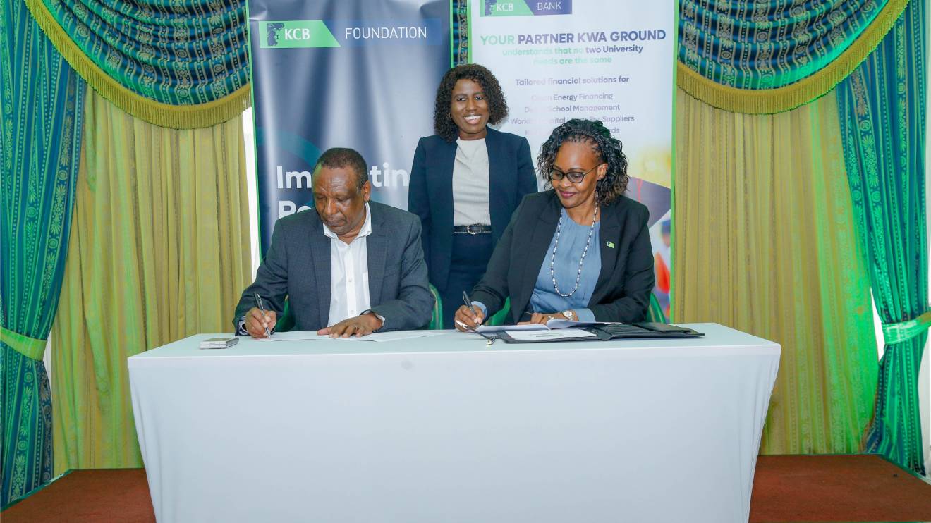 (L-R): Vice‑Chancellors Committee of Public Universities in Kenya , and KCB Bank Kenya Managing Director Annastacia Kimtai sign an MOU, as Principal Secretary for Higher Education and Research, Dr. Beatrice Muganda Inyangala, looks on. PHOTO/COURTESY