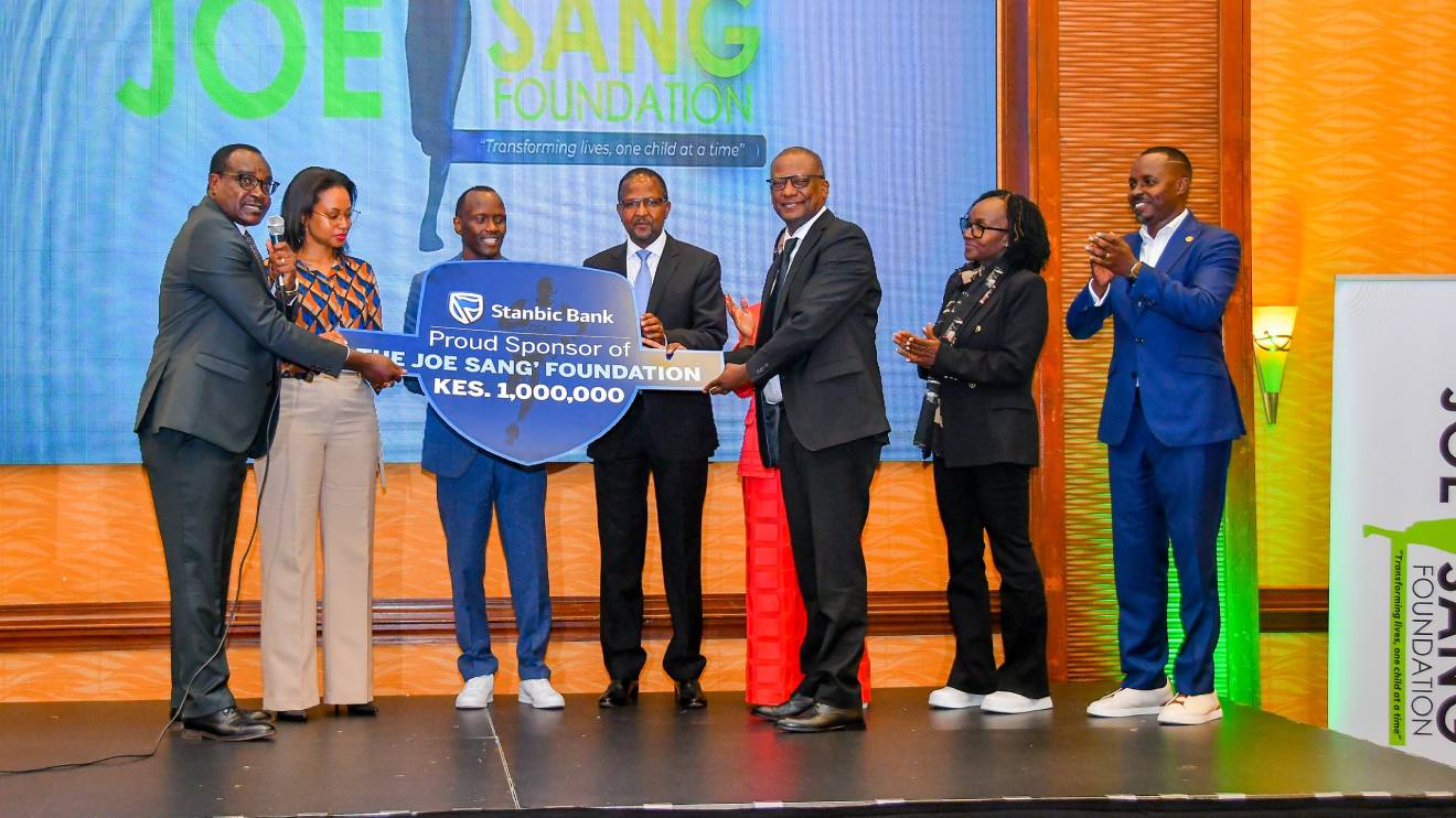 Joe Sang' (Third Left) receiving sponsorship from Stanbic Bank. PHOTO/COURTESY
